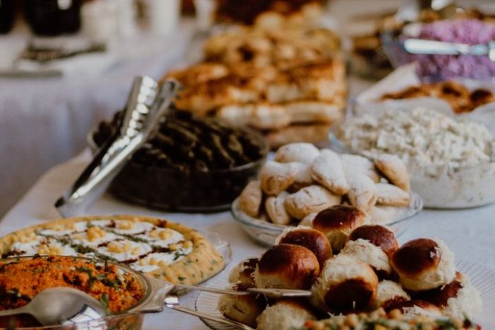 A diverse spread of Turkish dishes including pastries and salads on a table ready for celebration.