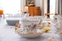 Charming porcelain tea set with floral patterns arranged elegantly on a table.